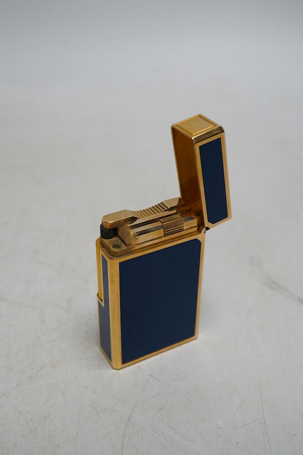 A Dupont gilt metal and blue enamel cigarette lighter with Japanese characters to the side, boxed with papers and a Piaget Montres Watches folding knife, cased. Condition - good